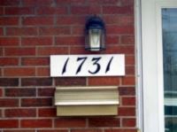 Photo of a brick house's address number