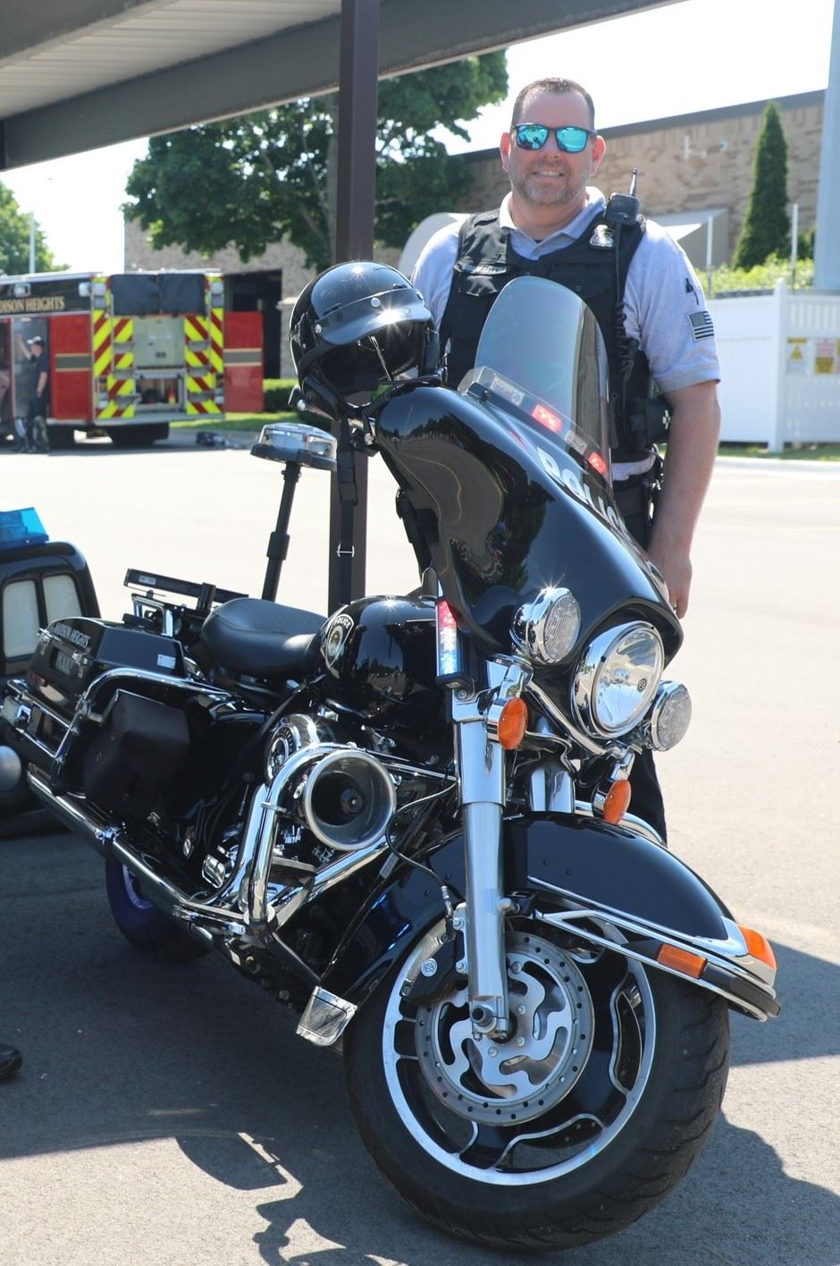 Officer standing next to a motorcycle outside